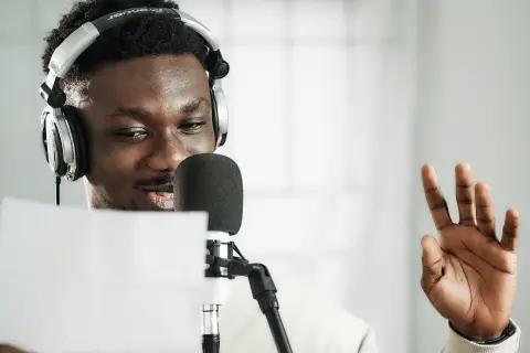 Man recording lines read from a sheet a paper